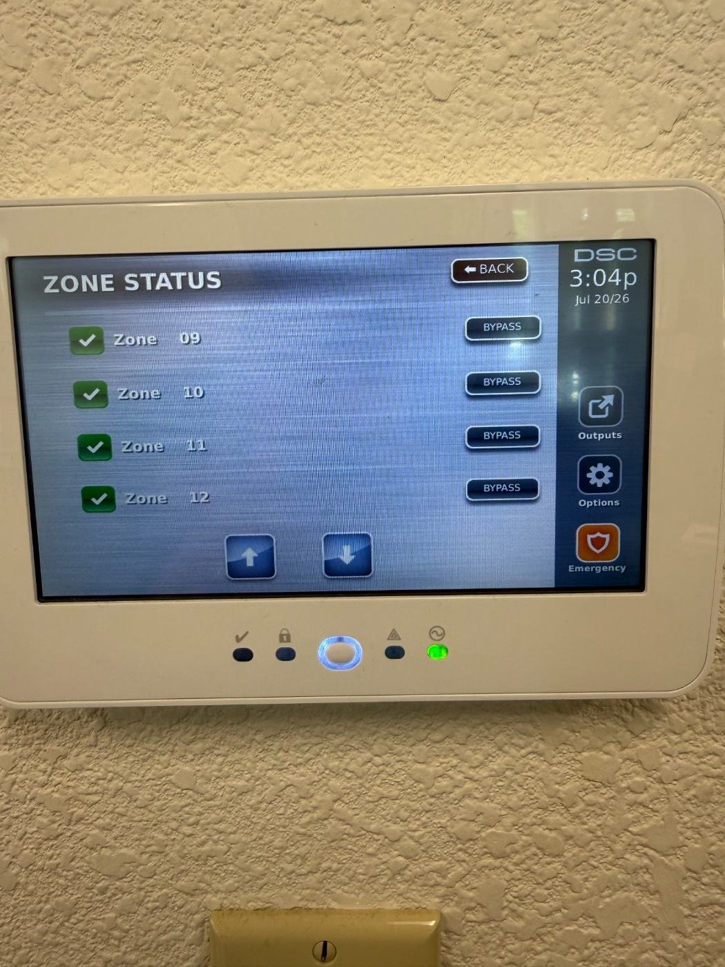 DSC touchscreen alarm keypad showing zone status for door and motion sensors in a Dallas home