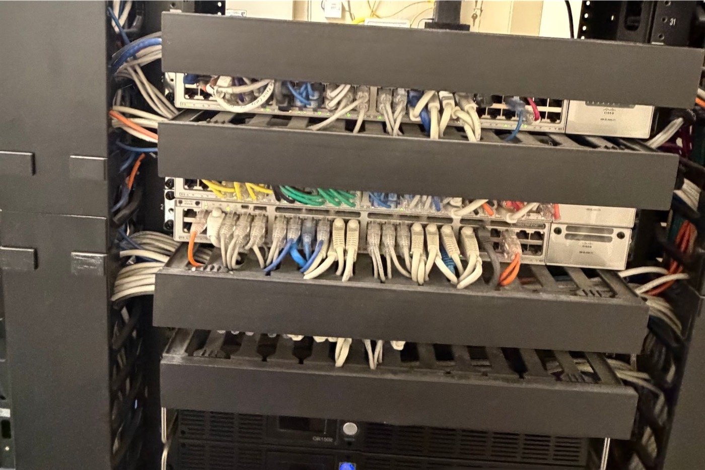 Commercial network rack with organized cabling serviced by A1 Security in DFW