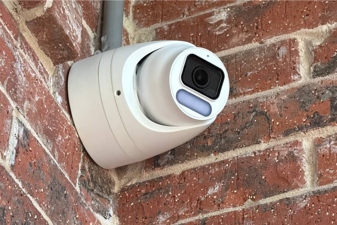 Security camera installed on a brick wall by A1 Security Gate & Intercom in DFW